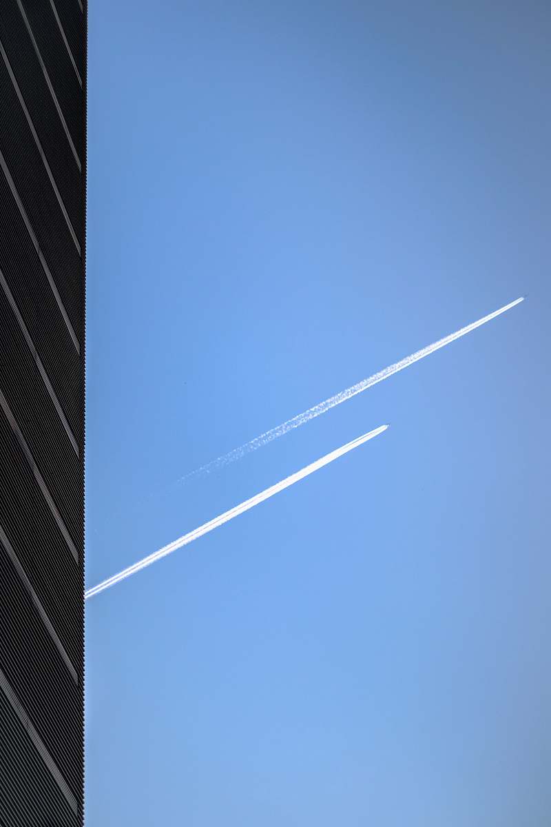 azure sky low-angle photography of two jet planes in the sky outdoors